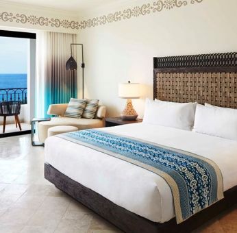 King bedroom with working station overlooking the ocean at the Hilton Los Cabos Beach & Golf Resort.