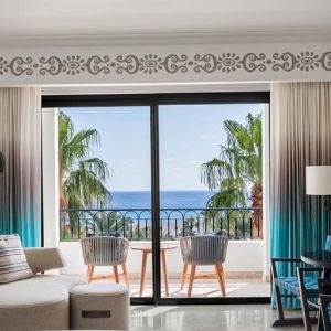 Living room with balcony perfect as workspace at the Hilton Los Cabos Beach & Golf Resort.