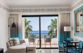 Living room with balcony perfect as workspace at the Hilton Los Cabos Beach & Golf Resort.