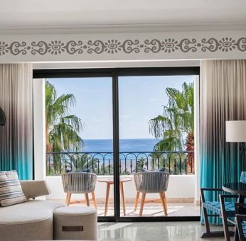 Living room with balcony perfect as workspace at the Hilton Los Cabos Beach & Golf Resort.