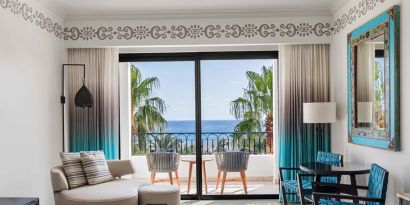 Living room with balcony perfect as workspace at the Hilton Los Cabos Beach & Golf Resort.