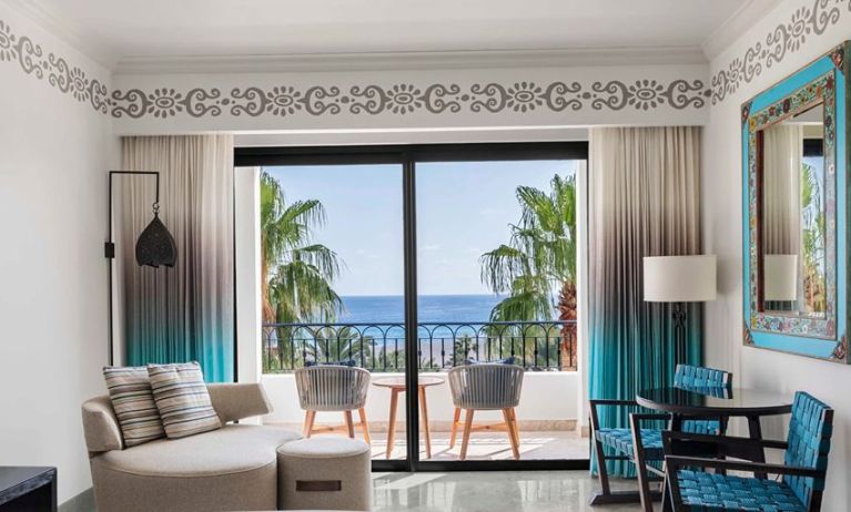 Living room with balcony perfect as workspace at the Hilton Los Cabos Beach & Golf Resort.