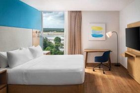 King bedroom with desk and TV screen at the Hilton Garden Inn Cancun Airport.