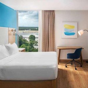 King bedroom with desk and TV screen at the Hilton Garden Inn Cancun Airport.