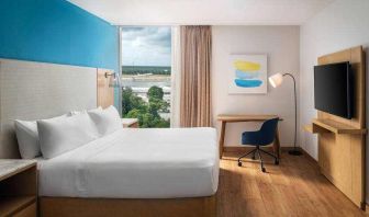 King bedroom with desk and TV screen at the Hilton Garden Inn Cancun Airport.