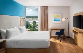 King bedroom with desk and TV screen at the Hilton Garden Inn Cancun Airport.