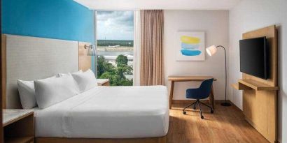 King bedroom with desk and TV screen at the Hilton Garden Inn Cancun Airport.