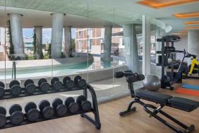 Fitness center with weights and machines at the Hilton Garden Inn Cancun Airport.