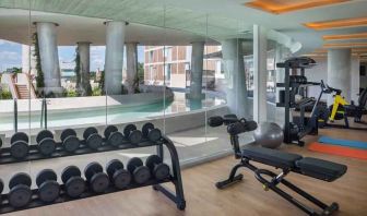 Fitness center with weights and machines at the Hilton Garden Inn Cancun Airport.