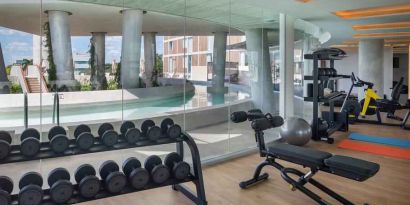 Fitness center with weights and machines at the Hilton Garden Inn Cancun Airport.