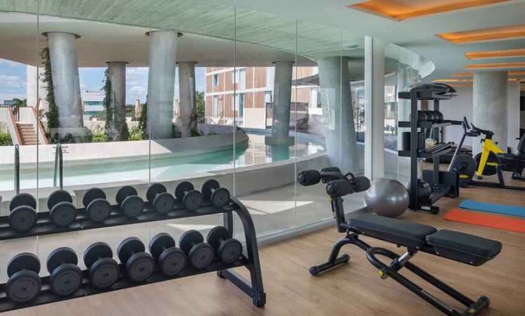 Fitness center with weights and machines at the Hilton Garden Inn Cancun Airport.