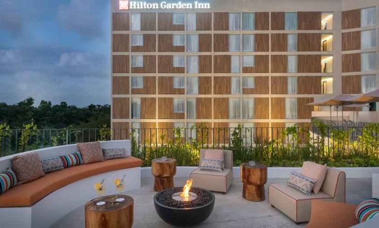 Terrace with firepit suitable for co-working at the Hilton Garden Inn Cancun Airport.