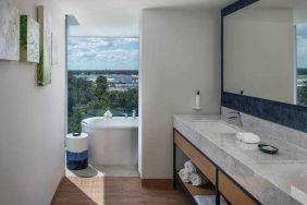 Bathroom with bath tub overlooking the airport at the Hilton Garden Inn Cancun Airport.