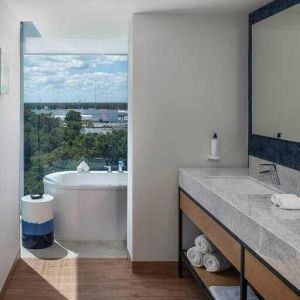 Bathroom with bath tub overlooking the airport at the Hilton Garden Inn Cancun Airport.