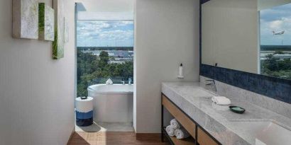 Bathroom with bath tub overlooking the airport at the Hilton Garden Inn Cancun Airport.