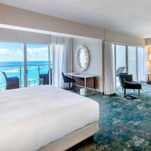 King suite with working station overlooking the sea at the Caribe Hilton.