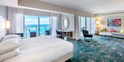 King suite with working station overlooking the sea at the Caribe Hilton.