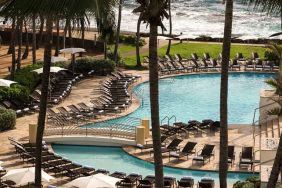 Relaxing outdoor pool area with lounges at the Caribe Hilton.