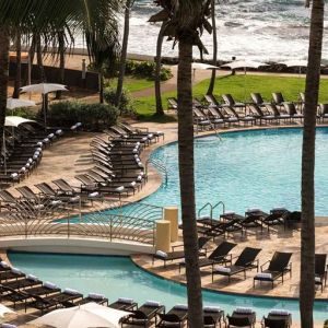 Relaxing outdoor pool area with lounges at the Caribe Hilton.