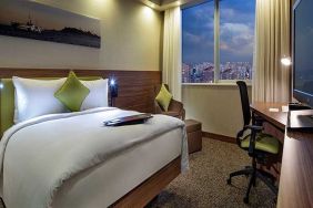 comfortable king bedroom with TV, desk, and chair at Hampton by Hilton Istanbul Kayasehir.