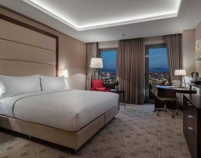 comfortable king bedroom with TV, desk, and chair at DoubleTree by Hilton Istanbul Topkapi.
