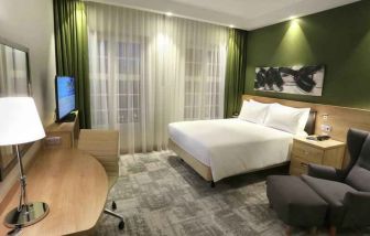 Queen room with desk and sofa at the Hampton by Hilton Gdansk Old Town.