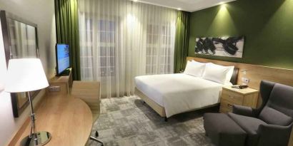 Queen room with desk and sofa at the Hampton by Hilton Gdansk Old Town.