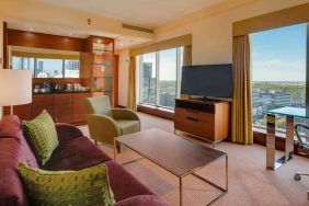 Spacious living room with view, working station and sofa at the Hilton Warsaw City.