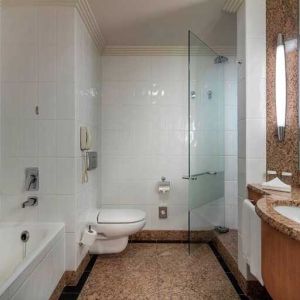 spacious bathroom with bath and shower at Adana HiltonSA.