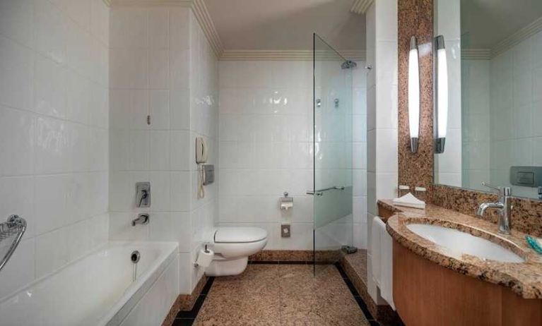 spacious bathroom with bath and shower at Adana HiltonSA.