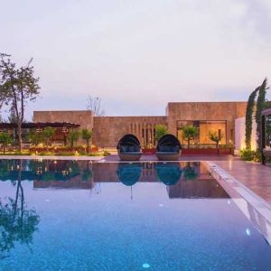 stunning outdoor pool with sun beds and seating area at Adana HiltonSA.