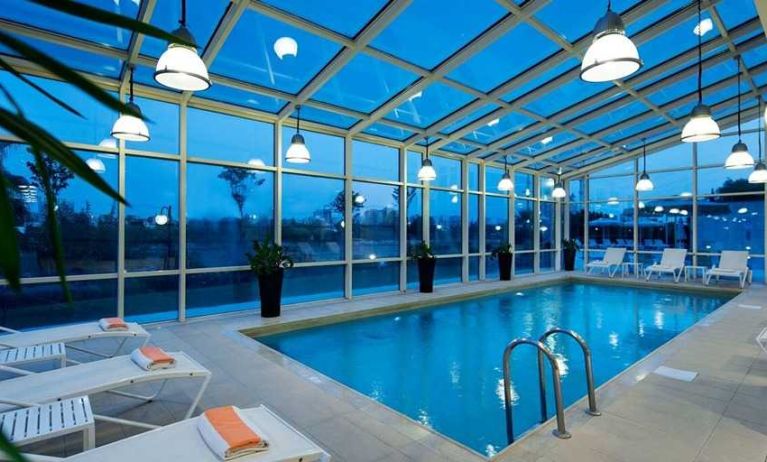 beautiful indoor pool with sunbeds at Adana HiltonSA.