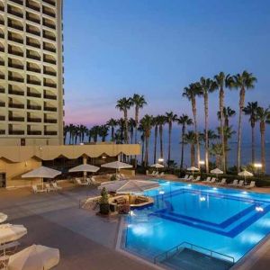 stunning outdoor pool with sun beds and seating area at Mersin HiltonSA.