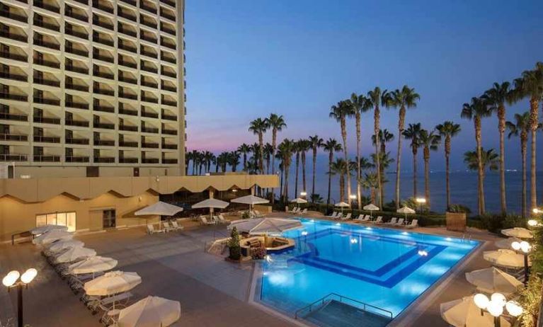 stunning outdoor pool with sun beds and seating area at Mersin HiltonSA.