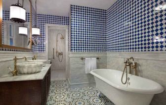 clean and spacious bathroom with bath and shower at Hagia Sofia Mansions Istanbul, Curio Collection by Hilton.