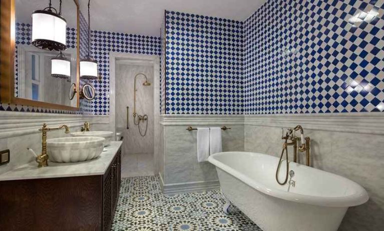 clean and spacious bathroom with bath and shower at Hagia Sofia Mansions Istanbul, Curio Collection by Hilton.