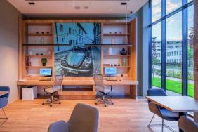 Business center with computers and workstations at the Hampton by Hilton Warsaw Mokotow.