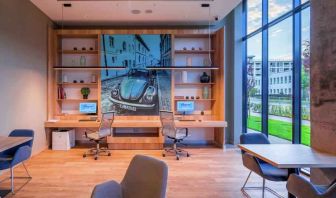 Business center with computers and workstations at the Hampton by Hilton Warsaw Mokotow.