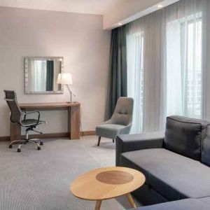 Living room with working station at the Hampton by Hilton Warsaw Mokotow.