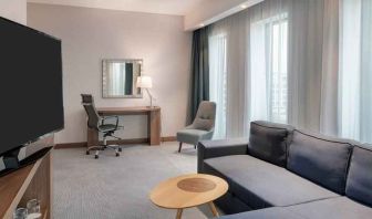 Living room with working station at the Hampton by Hilton Warsaw Mokotow.