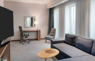 Living room with working station at the Hampton by Hilton Warsaw Mokotow.