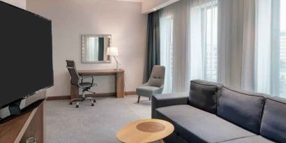 Living room with working station at the Hampton by Hilton Warsaw Mokotow.