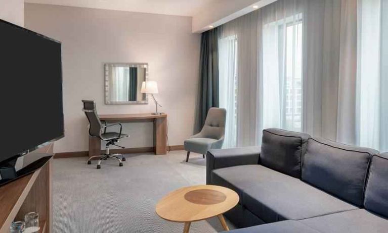 Living room with working station at the Hampton by Hilton Warsaw Mokotow.