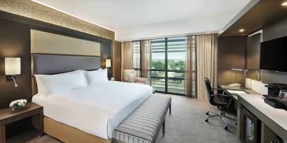 King bedroom with desk at the Legend Hotel Lagos Airport, Curio Collection by Hilton.