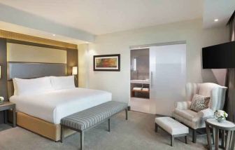 Elegant king suite with TV screen at the Legend Hotel Lagos Airport, Curio Collection by Hilton.