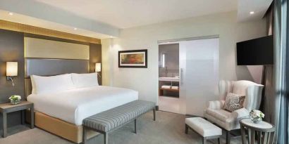 Elegant king suite with TV screen at the Legend Hotel Lagos Airport, Curio Collection by Hilton.