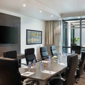 Meeting room with TV screen at the Legend Hotel Lagos Airport, Curio Collection by Hilton.