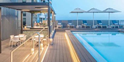 Outdoor pool area with lounges at the Hilton Garden Inn Umhlanga Arch.