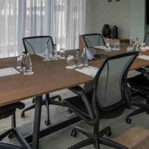 Meeting room with small table and TV screen at the Hilton Garden Inn Umhlanga Arch.