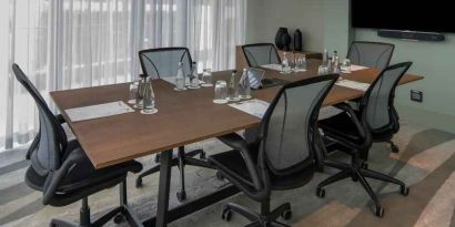 Meeting room with small table and TV screen at the Hilton Garden Inn Umhlanga Arch.